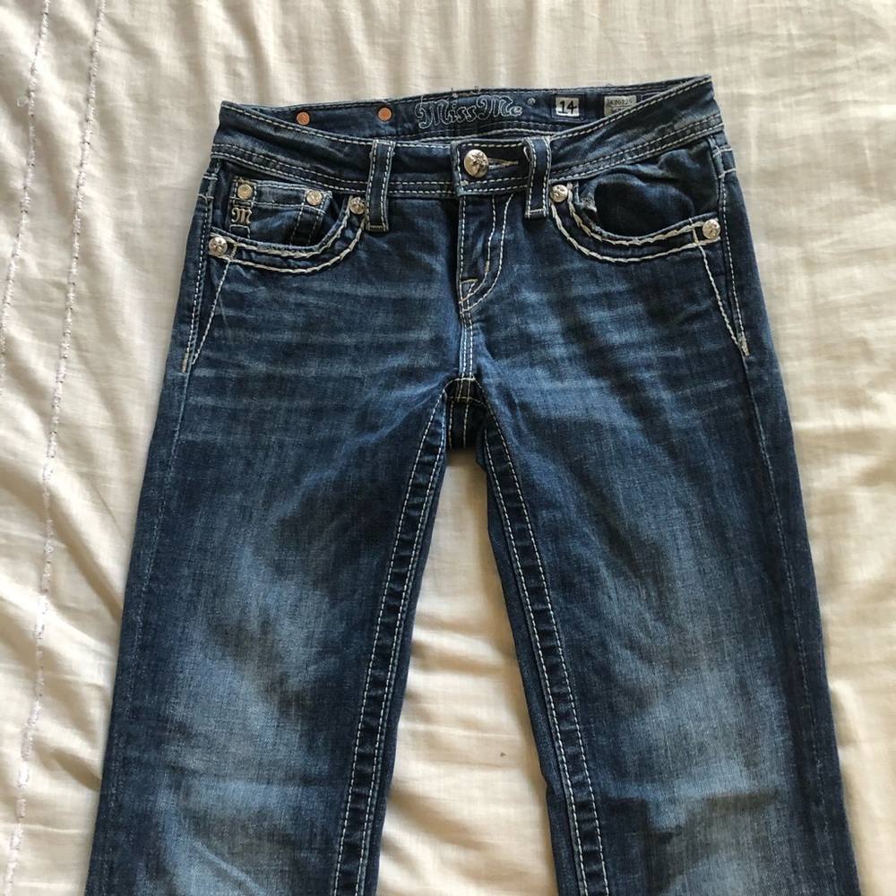 Miss Me Jeans with wings on the back pockets.